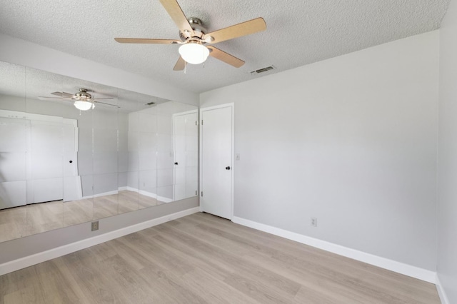 33563 Frazier Rd, Auberry, CA 93602 - spare room with a textured ceiling, a ceiling fan, wood finished floors, and baseboards