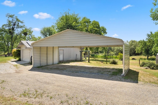 view of parking with a detached garage