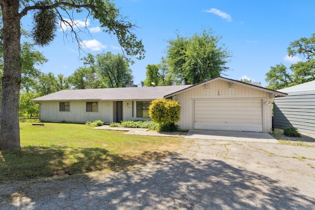 ranch-style house with a front lawn, driveway, and an attached garage