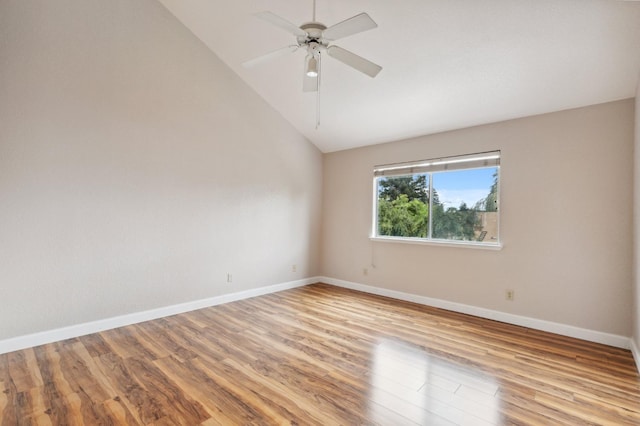 unfurnished room with baseboards, vaulted ceiling, ceiling fan, and light wood-type flooring