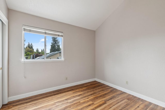 empty room with baseboards and wood finished floors