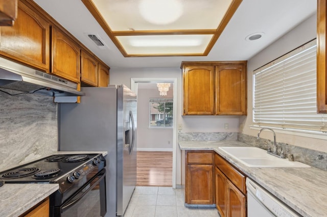 kitchen with a sink, dishwasher, light countertops, under cabinet range hood, and black range with electric stovetop