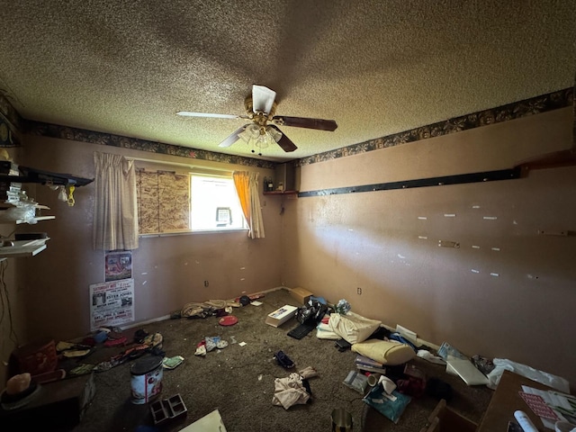 unfurnished room with carpet floors, a ceiling fan, and a textured ceiling