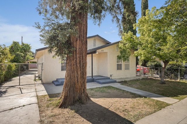 635 N San Pablo Ave, Fresno, CA 93728 - view of front of house featuring fence, a gate, and stucco siding