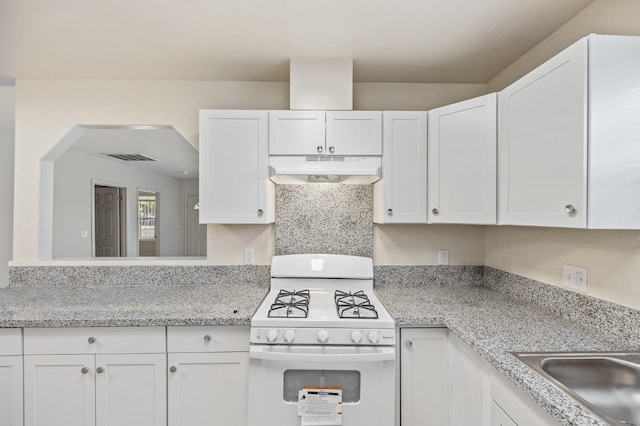 635 N San Pablo Ave, Fresno, CA 93728 - kitchen featuring visible vents, white range with gas cooktop, white cabinetry, under cabinet range hood, and a sink