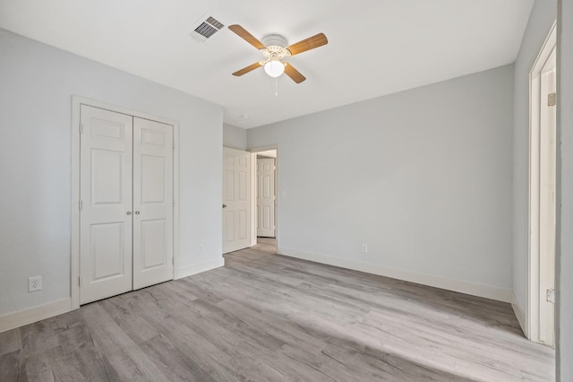635 N San Pablo Ave, Fresno, CA 93728 - unfurnished bedroom with ceiling fan, visible vents, wood finished floors, baseboards, and a closet