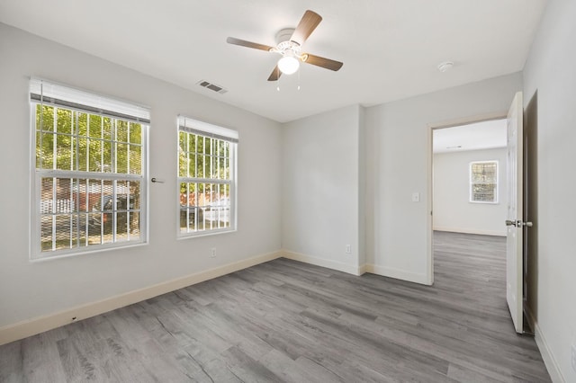 635 N San Pablo Ave, Fresno, CA 93728 - spare room featuring baseboards, ceiling fan, wood finished floors, and visible vents