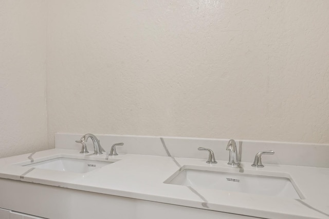 635 N San Pablo Ave, Fresno, CA 93728 - bathroom with double vanity, a sink, and a textured wall