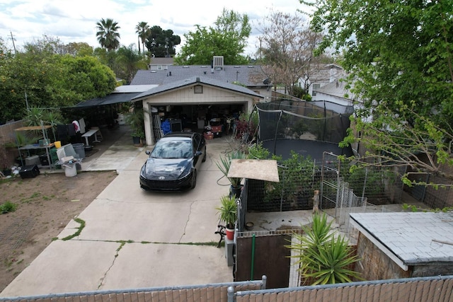 3535 E Grant Ave, Fresno, CA 93702 - view of front facade featuring concrete driveway, a trampoline, and a garage