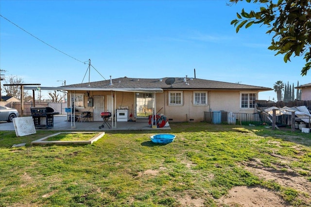 4185 E Turner Ave, Fresno, CA 93702 - rear view of property with a patio, a lawn, fence, and stucco siding