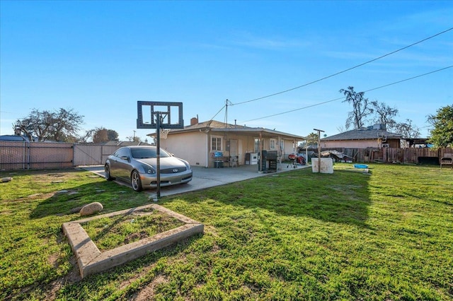 4185 E Turner Ave, Fresno, CA 93702 - back of house with a fenced backyard, a yard, and a patio area