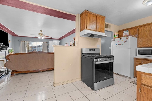 4185 E Turner Ave, Fresno, CA 93702 - kitchen with visible vents, white appliances, tile counters, under cabinet range hood, and a ceiling fan