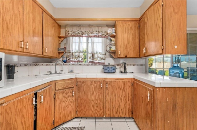 4185 E Turner Ave, Fresno, CA 93702 - kitchen with light countertops, light tile patterned floors, plenty of natural light, and a sink