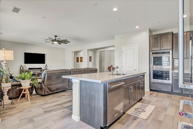 1938 W Van Gogh St, Hanford, CA 93230 - kitchen with ceiling fan, appliances with stainless steel finishes, a sink, light countertops, and light wood-type flooring