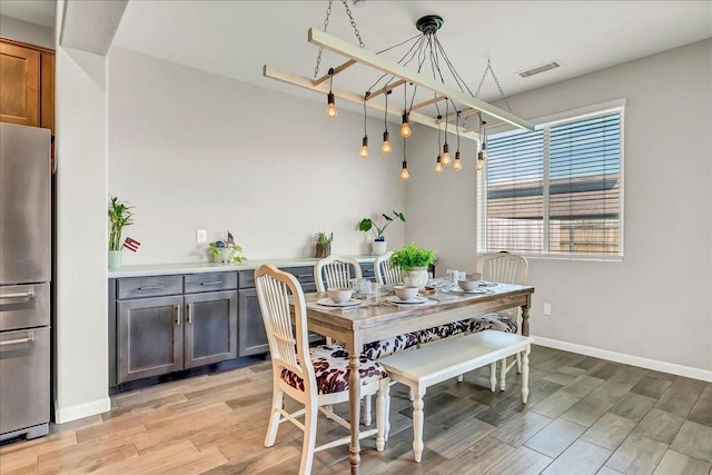 1938 W Van Gogh St, Hanford, CA 93230 - dining area with baseboards, light wood finished floors, and visible vents