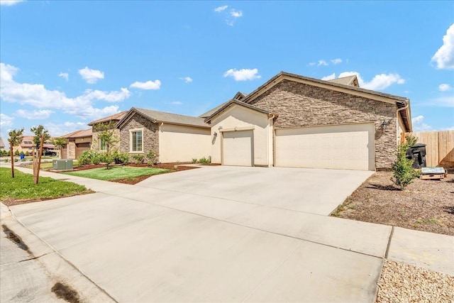 1938 W Van Gogh St, Hanford, CA 93230 - ranch-style house featuring fence, driveway, stone siding, and a garage