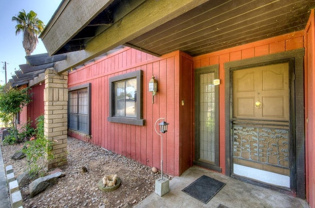 doorway to property featuring board and batten siding