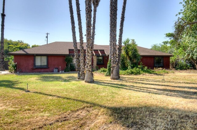 ranch-style house with a front lawn