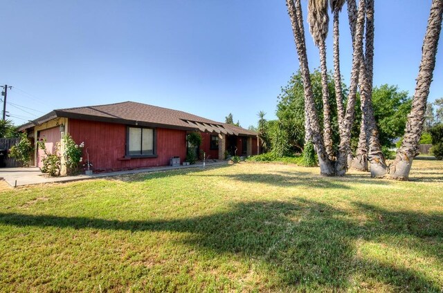view of yard with an attached garage and concrete driveway
