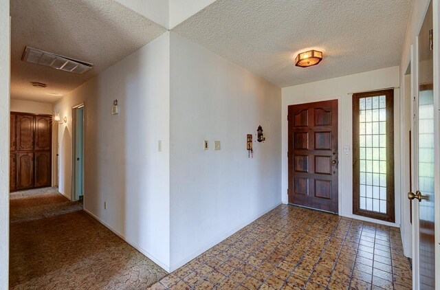 entrance foyer with a textured ceiling and visible vents