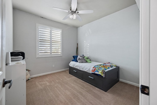 bedroom with a ceiling fan, baseboards, and light carpet