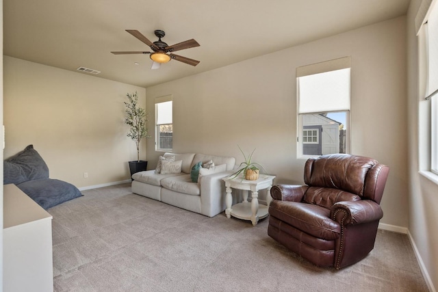 living area with baseboards, carpet, a ceiling fan, and visible vents