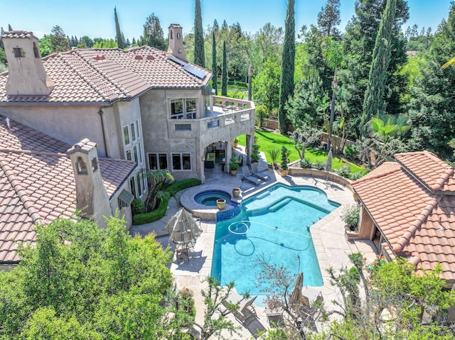 view of pool featuring a patio area and a pool with connected hot tub