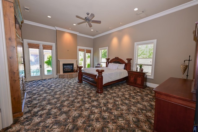 bedroom with carpet floors, a glass covered fireplace, recessed lighting, visible vents, and ornamental molding