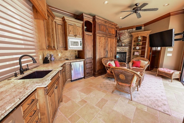 kitchen featuring dishwasher, ornamental molding, a sink, and white microwave