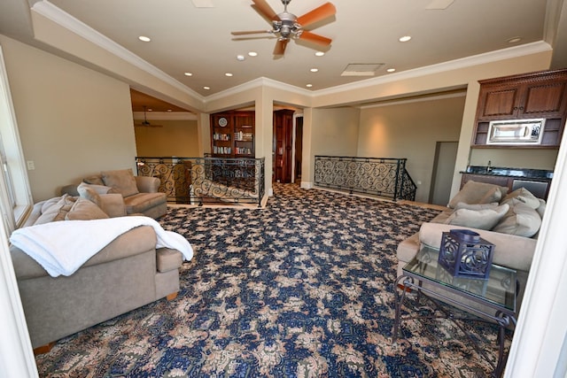 carpeted living area featuring ornamental molding, a ceiling fan, and recessed lighting