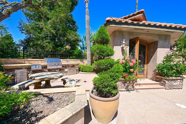 view of patio / terrace featuring fence, grilling area, and area for grilling