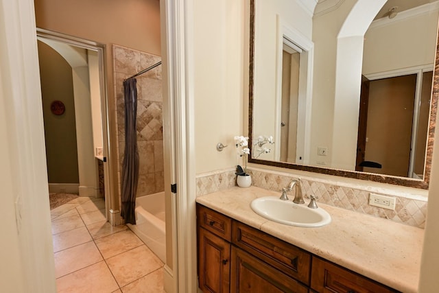 bathroom featuring tile patterned floors, decorative backsplash, shower / bath combo with shower curtain, and vanity