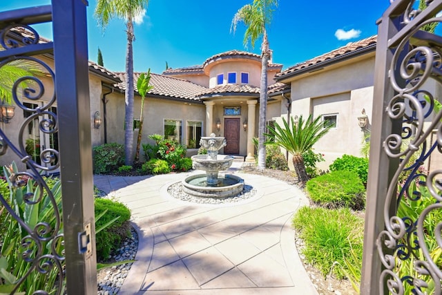 view of front of home featuring a tile roof and stucco siding