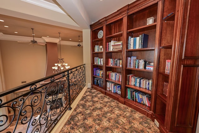 hall with crown molding, recessed lighting, an inviting chandelier, and wood finished floors