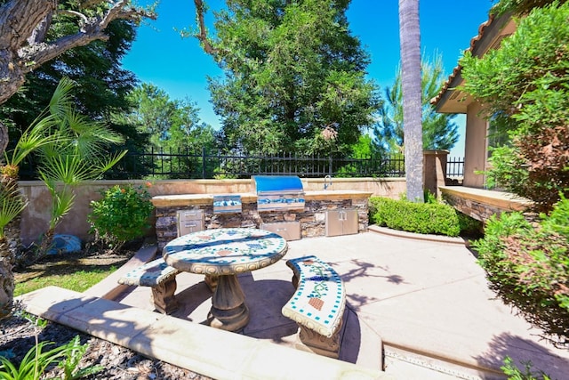 view of patio / terrace with grilling area, exterior kitchen, and fence