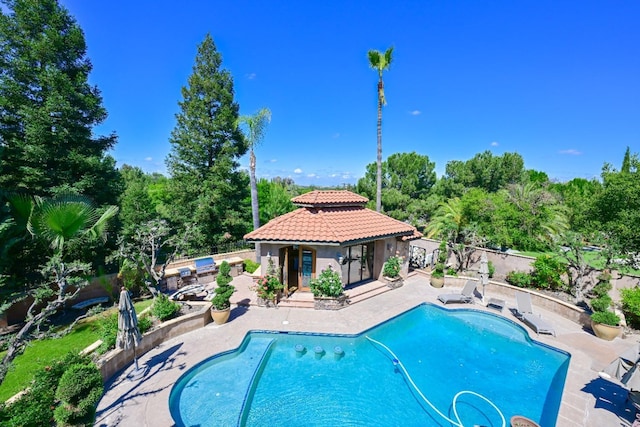 view of swimming pool featuring a fenced backyard, a fenced in pool, and a patio