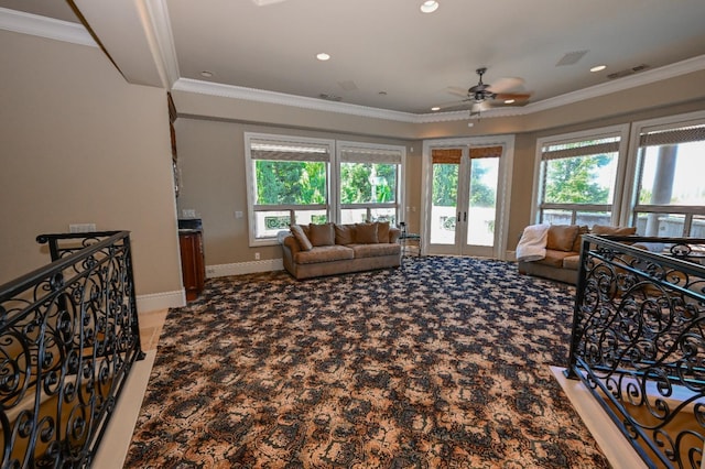 living area featuring ceiling fan, ornamental molding, carpet flooring, and visible vents