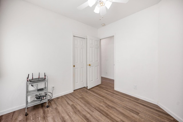 bedroom with baseboards, ceiling fan, and wood finished floors