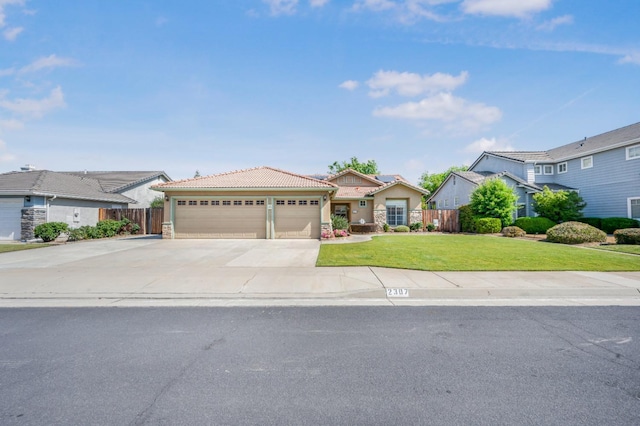view of front facade featuring concrete driveway, fence, a tile roof, and a front lawn