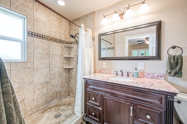 full bathroom featuring vanity, a shower stall, and toilet