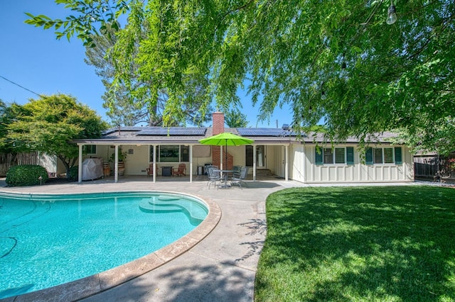 view of swimming pool with a lawn, a fenced in pool, a fenced backyard, and a patio area