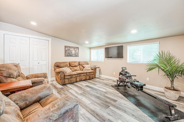 living room with baseboards, vaulted ceiling, recessed lighting, and wood finished floors
