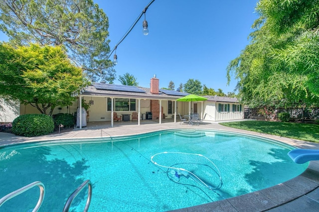 view of pool with a fenced backyard, a fenced in pool, a patio area, a lawn, and a water slide