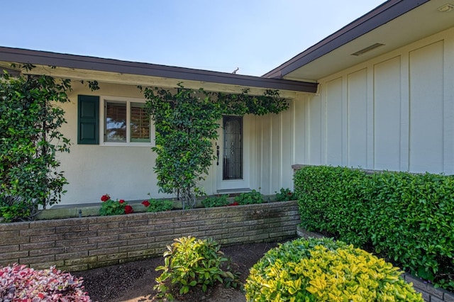 doorway to property featuring board and batten siding