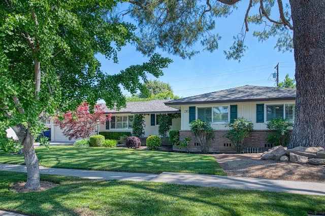 split level home with brick siding and a front lawn