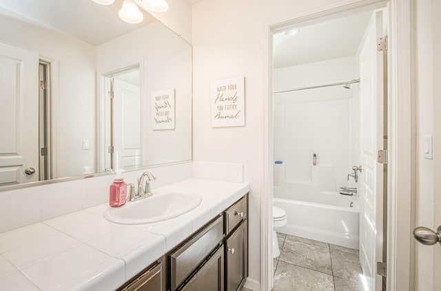 bathroom with vanity, toilet, and shower / washtub combination