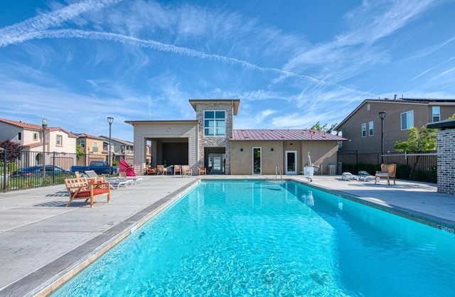pool featuring a patio and fence