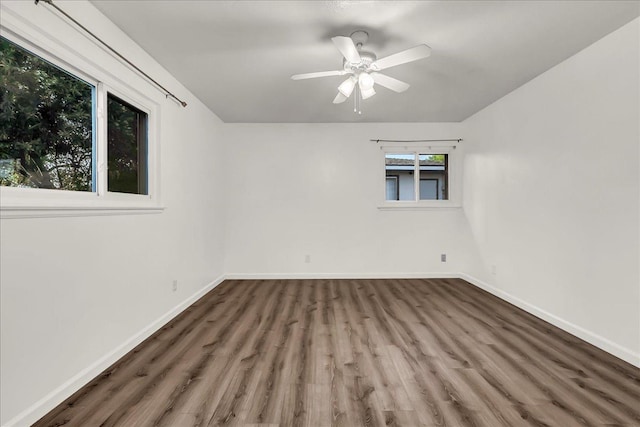 unfurnished room featuring baseboards, ceiling fan, and wood finished floors