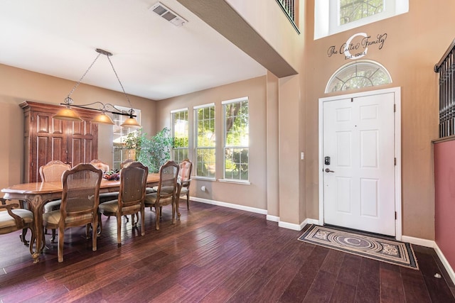 entryway with baseboards, wood-type flooring, and visible vents
