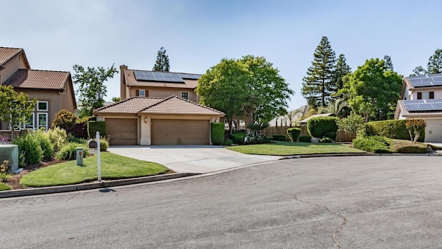 traditional home featuring a front yard, stucco siding, concrete driveway, a tile roof, and solar panels